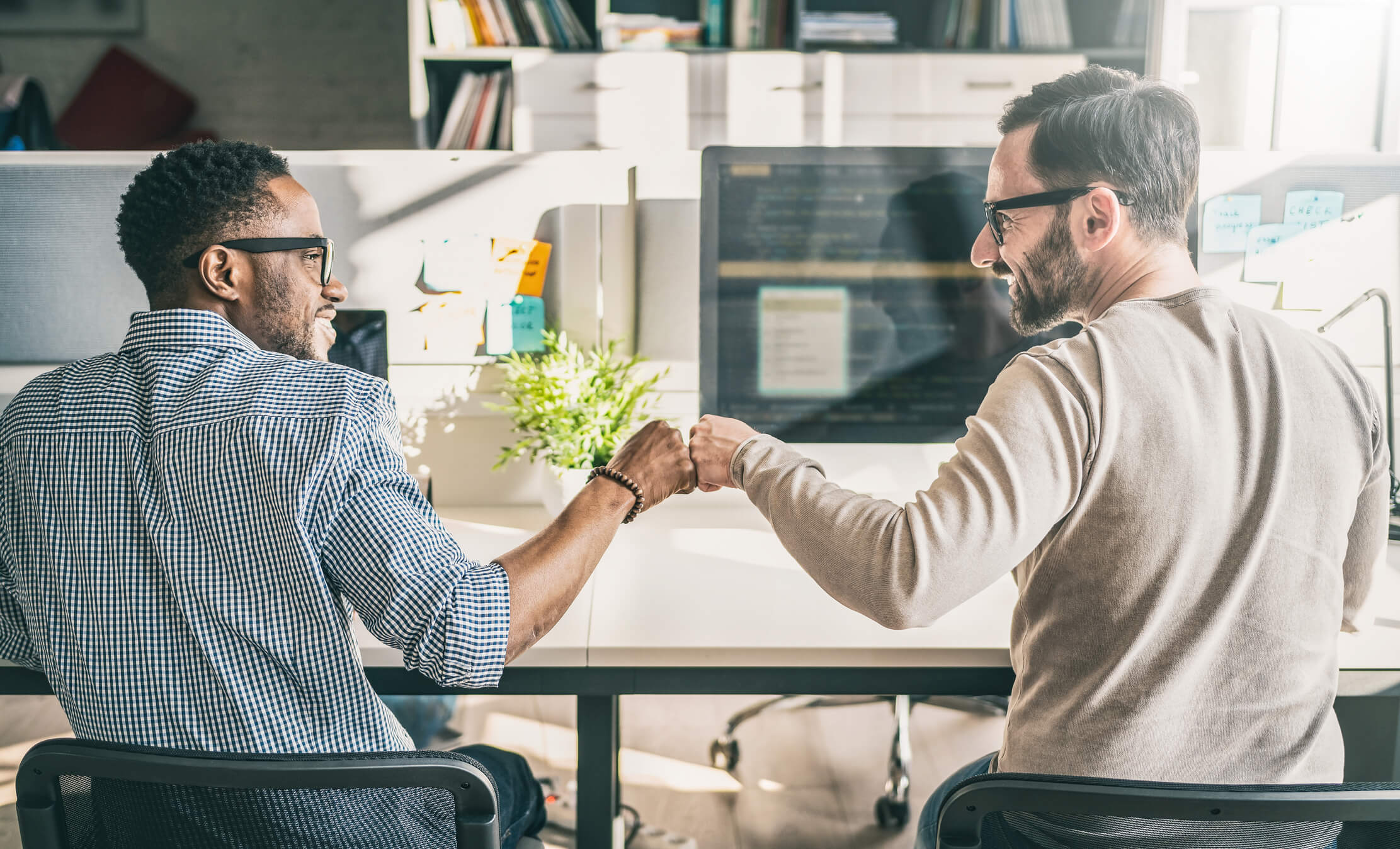 two men fist bumping